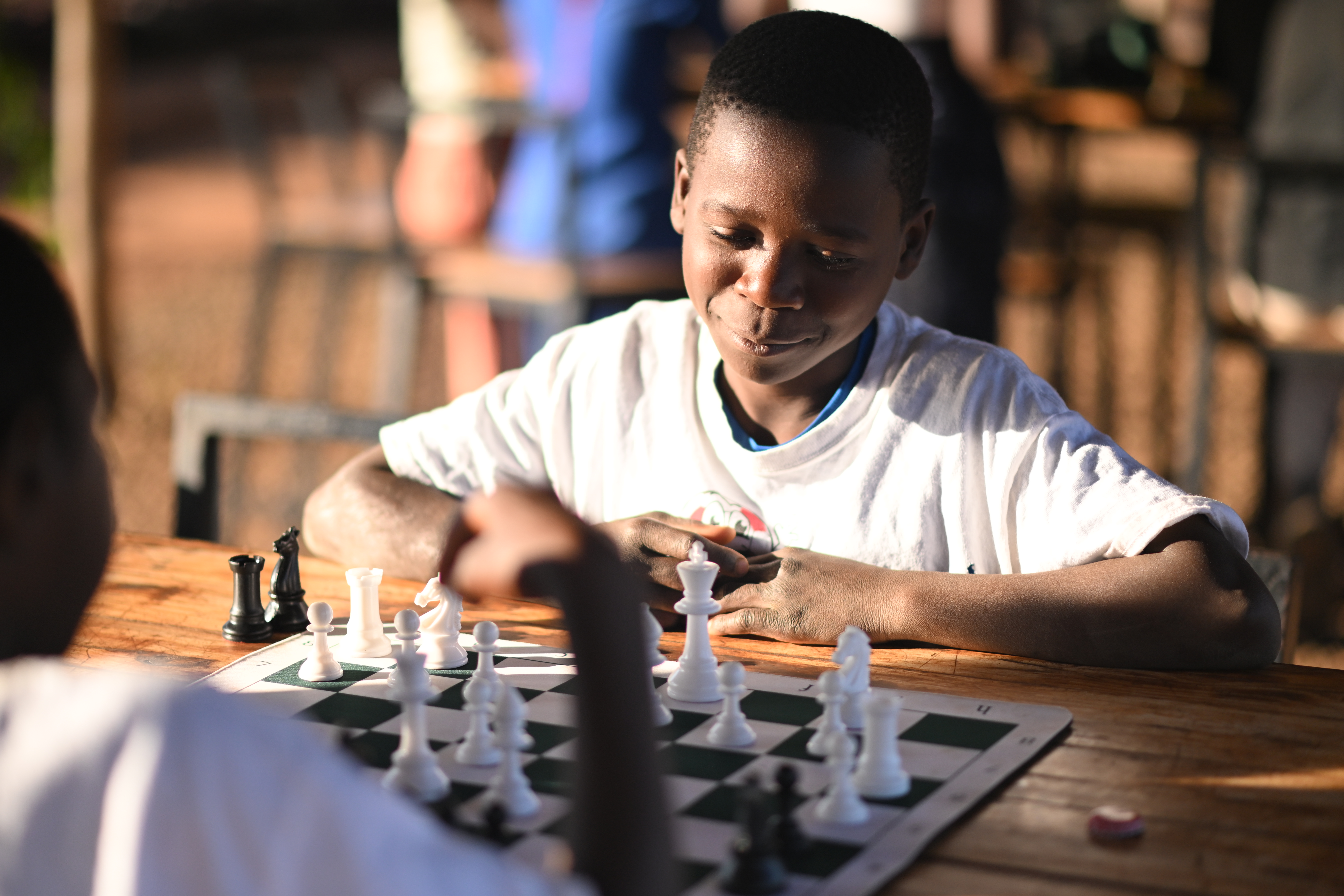 Children playing chess in our after-school program